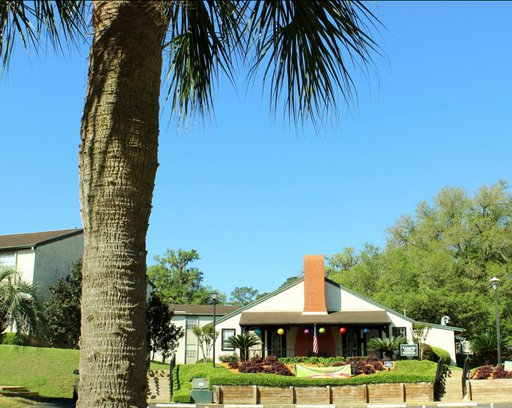 image of the front of the main office, blue sky and leafy trees